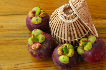 Fishing creel,coop-like trap for catching fish /Thai native equipment and mangosteens.
