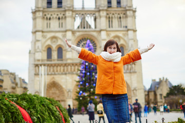 Happy young woman in Paris at Christmas