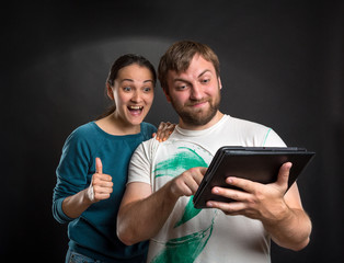 Couple playing with tablet