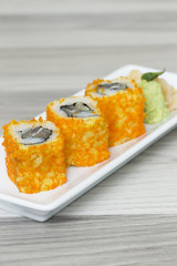 Sushi rolls with shrimps eggs and seaweed on a dish