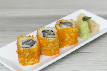 Sushi rolls with shrimps eggs and seaweed on a plate