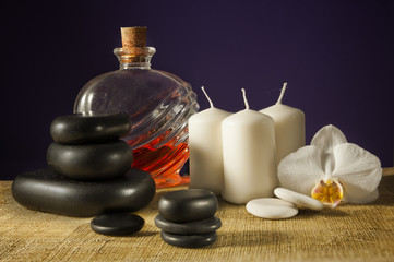 Spa concept - massage stones on purple