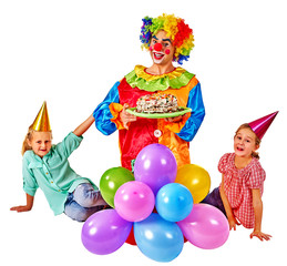 Obraz na płótnie Canvas Clown keeps cake on birthday with two children . Birthday decoration with balloons. Isolated.