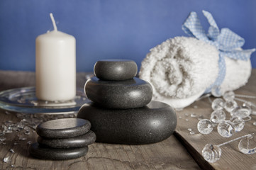 Obraz na płótnie Canvas Blue white spa set. Massage stones, candle, towel.