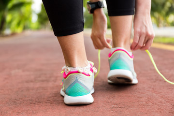 Sport woman tying shoe laces