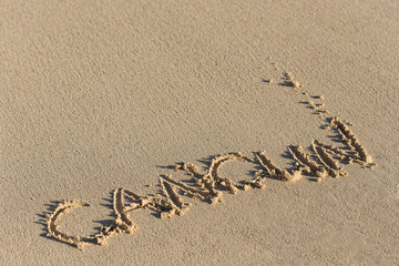 Inscription Cancun on sandy beach