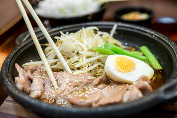 Korean spicy bbq pork served on a hot plate with side dishes.
