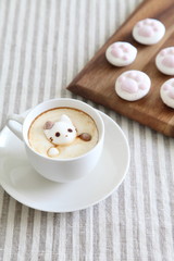 Coffee in white mug with melted cat shaped marshmallow & cat paw shaped marshmallows