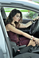 Fototapeta na wymiar She shifts gears while riding in the car