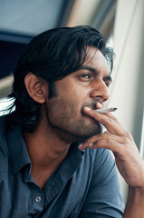 Handsome man smoking cigarette.