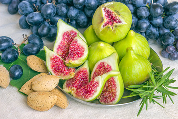 Still life of fresh colorful fruits. Bunch of black grapes, gree