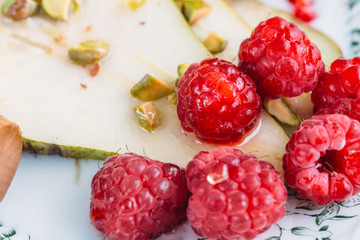 pear with raspberry and honey. healthy breakfast