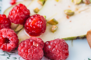 pear with raspberry and honey. healthy breakfast