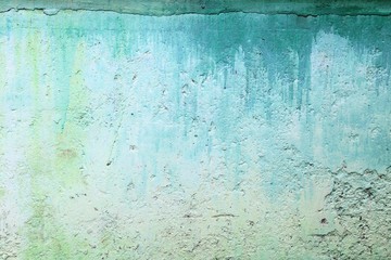 Painted concrete photo texture. Lime wall grunge background. Coating cement surface backdrop with paint streaks.
