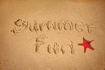 summer fun written on sand