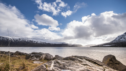Fjord in Norway with blue sky and clouds