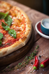 Italian pizza with basil leaves