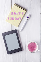 Berry smoothie and an inscription in notebook: Happy sunday