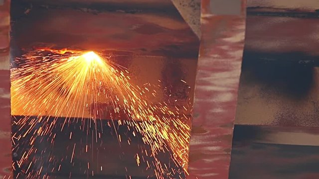 Workers polishing and welding during reparation of ship in shipyard with protective equipment