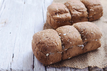 Close up of fresh wholegrain bread loaf on a wooden table.