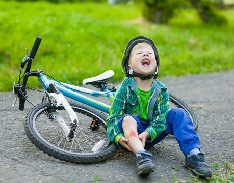 boy fell from the bike in a park