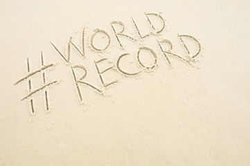 Hashtag social media message for World Record written in smooth sand on the beach in Rio de Janeiro, Brazil
