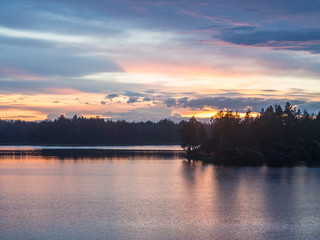Fototapeta na wymiar sunset over the forest lake