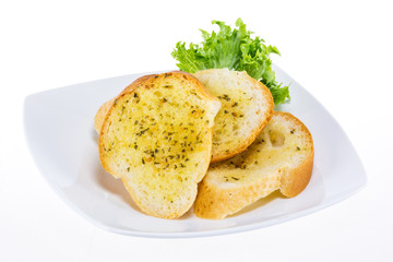 Garlic bread on white plate