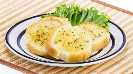 Garlic bread on white plate