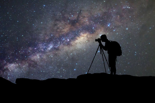 Fototapeta silhouette  of man photography take a photo of Milky Way galaxy