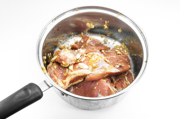 raw steak in frying pan isolated on white background