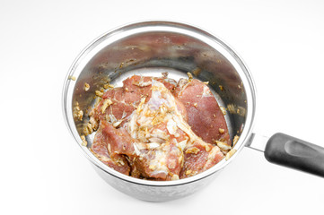 raw steak in frying pan isolated on white background
