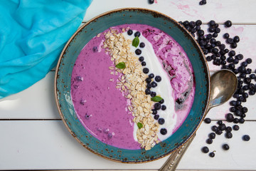 delicious porridge with blueberries on white table