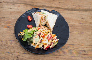 Sandwiches, salads, vegetables, sauce on the wooden floor.