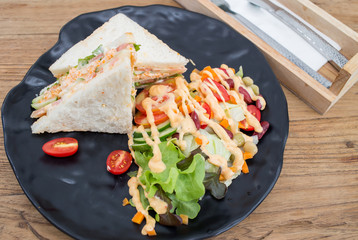 Sandwiches, salads, vegetables, sauce on the wooden floor.