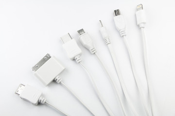 7 different cellphone charging plugs adapter from USB isolated on white background