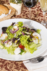 Greek salad on a white background in the restaurant