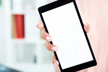 Closeup of  blank smart phone screen in female hands.