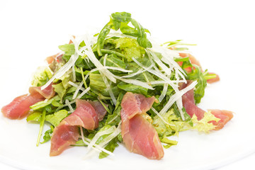 salad of arugula and tuna vegetables on a white background in the restaurant