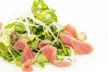 salad of arugula and tuna vegetables on a white background in the restaurant