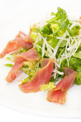 salad of arugula and tuna vegetables on a white background in the restaurant