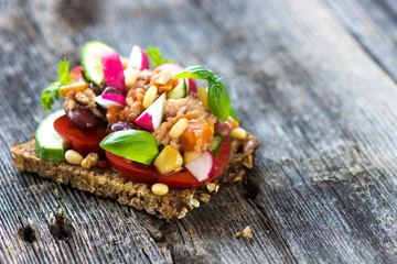 Delicious healthy sandwich with crunchy wholemeal bread on a wooden background