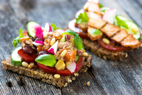Delicious healthy sandwich with crunchy wholemeal bread on a wooden background