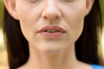 Close up on the parted lips of a thin woman