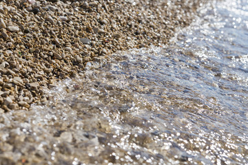 Sea wave on pebble beach