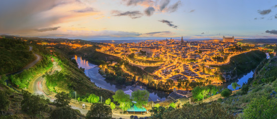 Night view of Toledo cityscape and Tagus River from the hill, Castilla la Mancha, Spain - obrazy, fototapety, plakaty