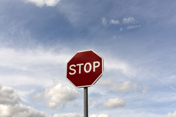 Stop sign against cloudy sky.
