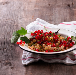 red and white currant on wooden background