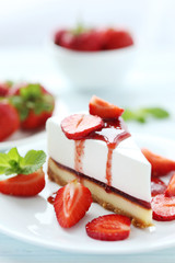 Strawberry cheesecake on plate on blue wooden table