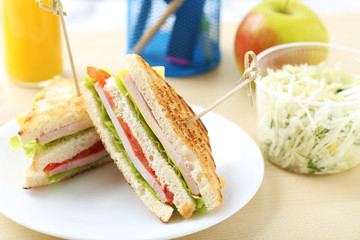 Tasty and fresh sandwiches on a brown table